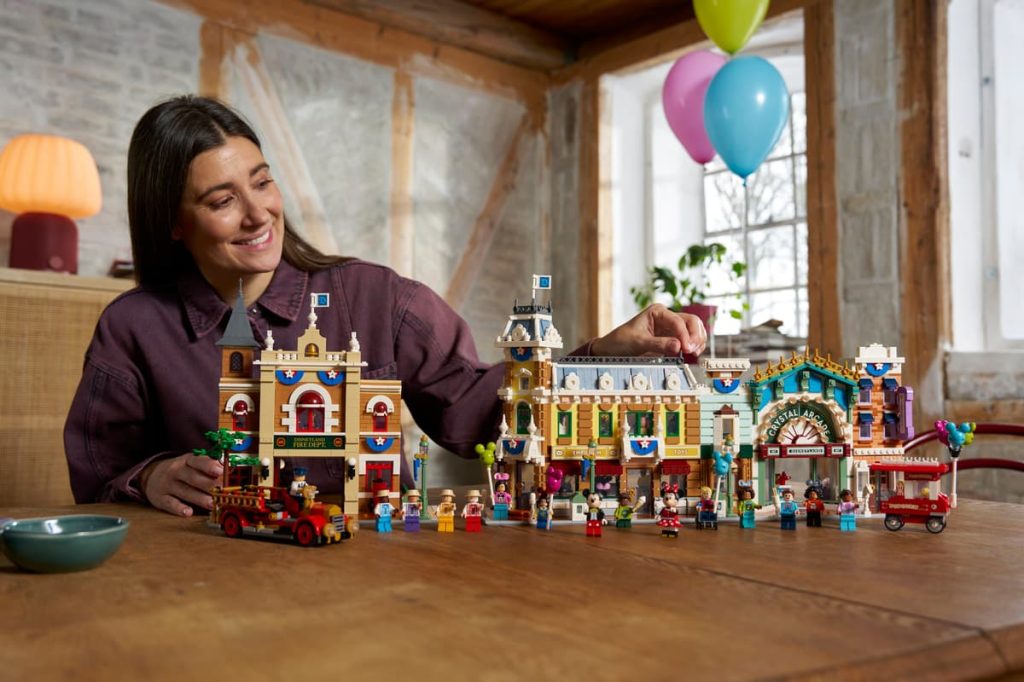 A woman sitting at a table with a toy building set