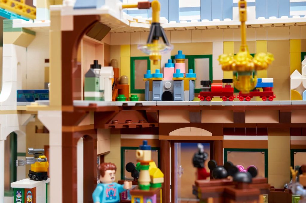 A toy building with a man and a child