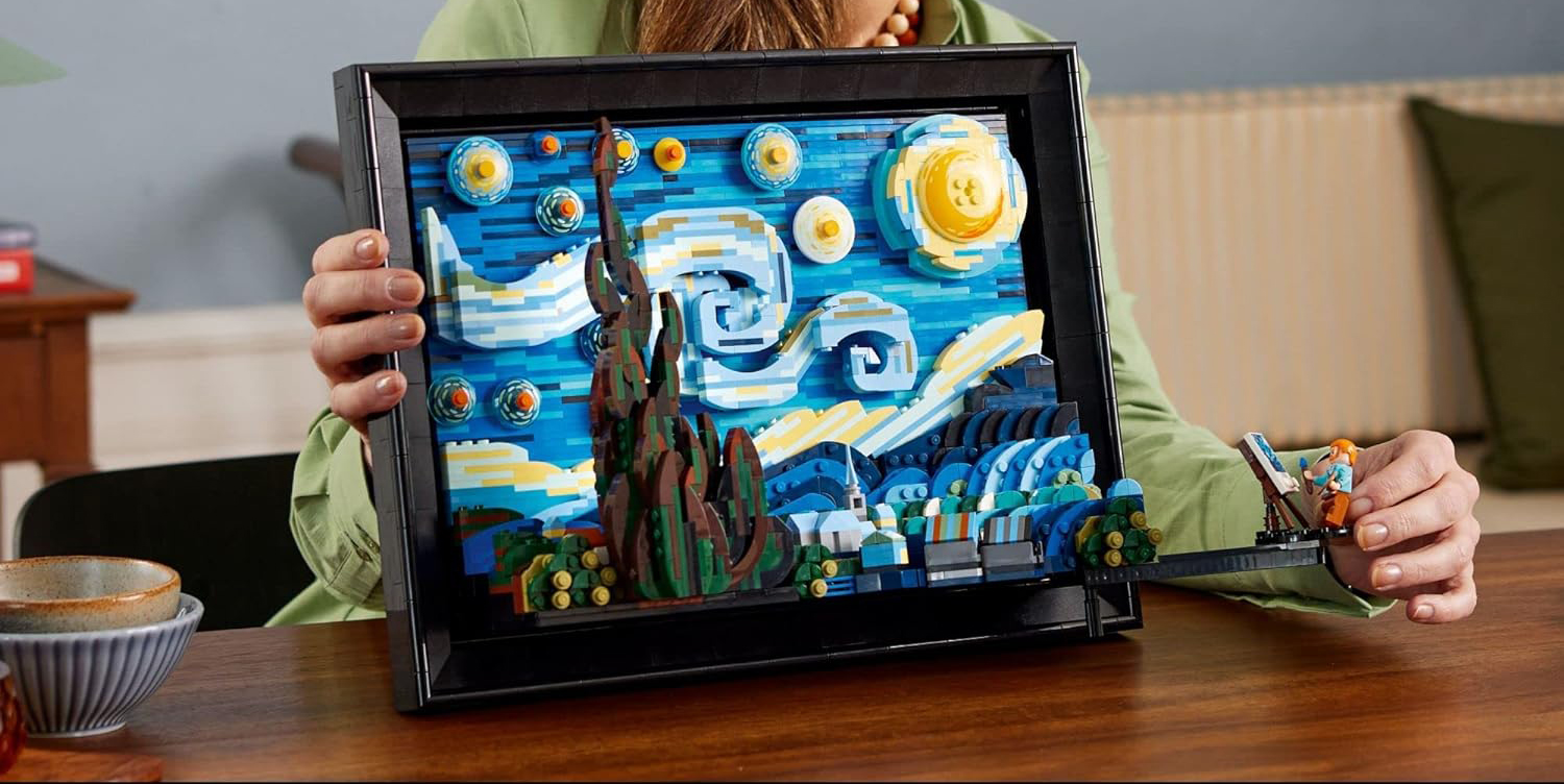 A person holding a picture of a painting
