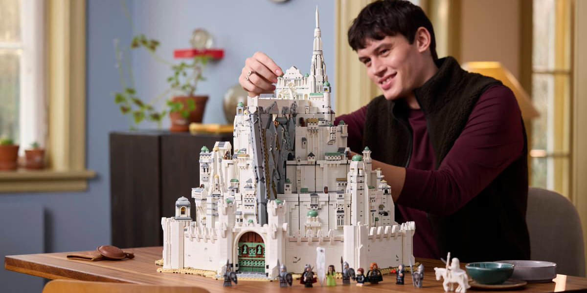 A man playing with a building toy castle