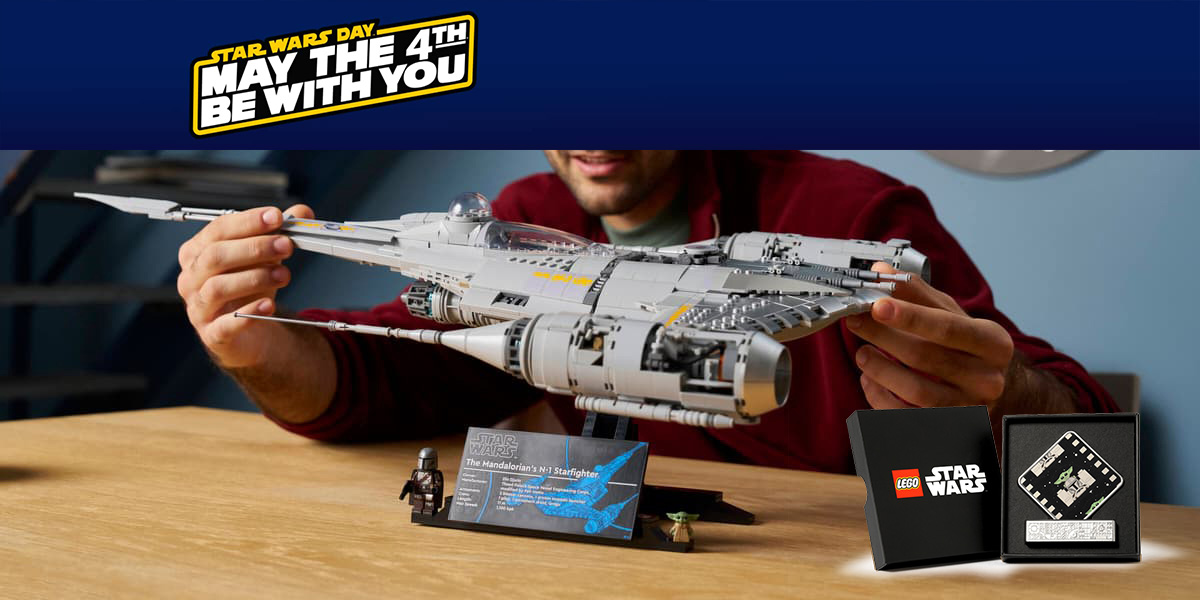 A man holding a toy model of a spaceship