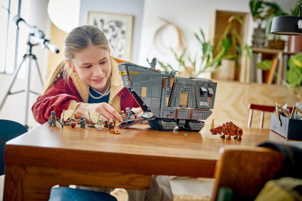 A girl playing with lego toys