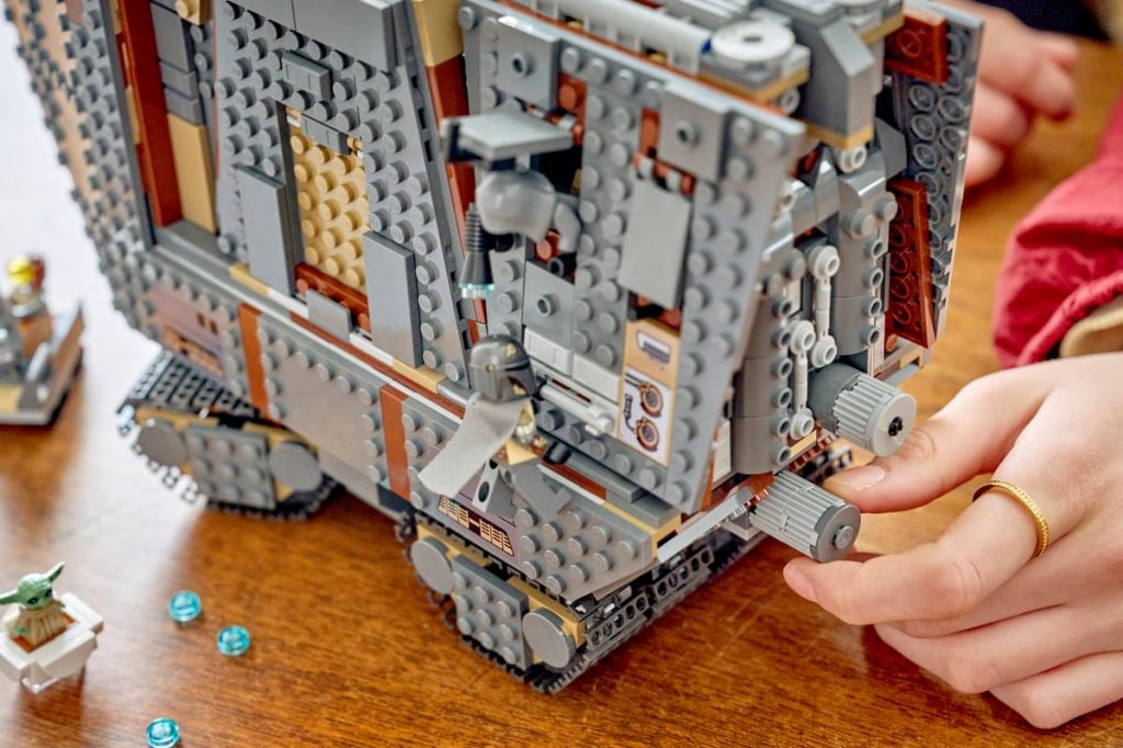 A hand touching a toy