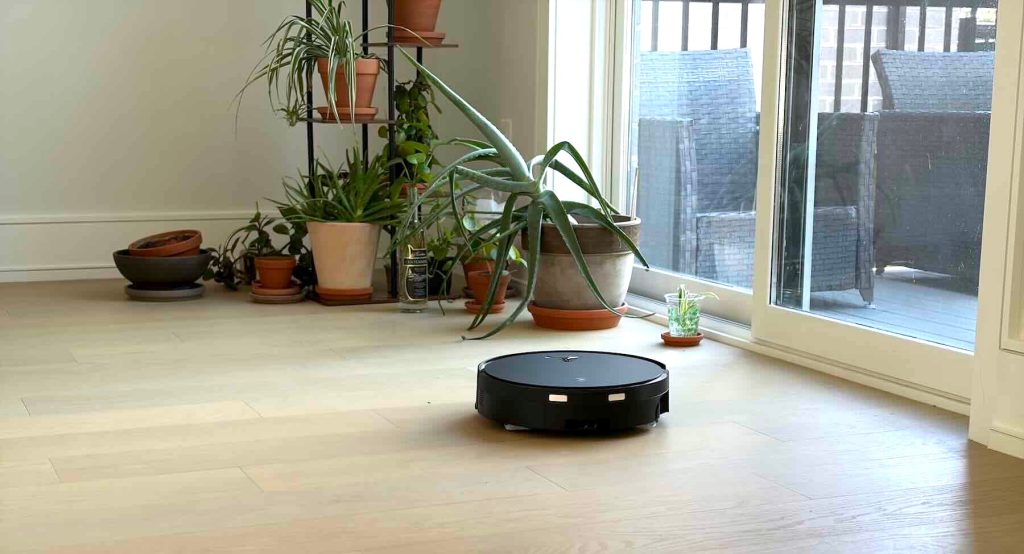A robot vacuum cleaner on a wood floor