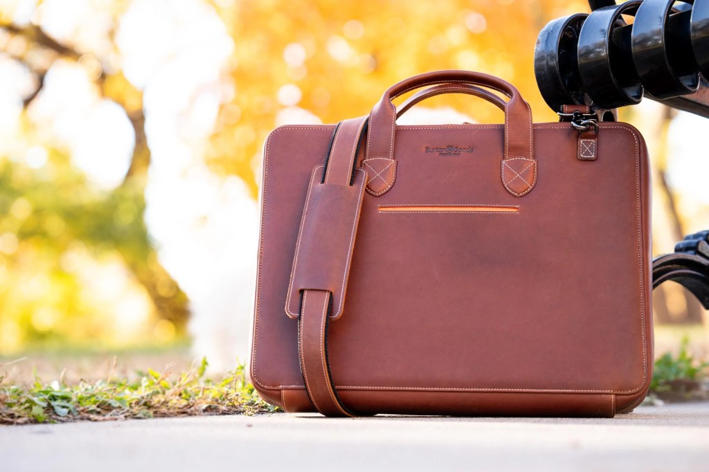 A brown leather briefcase on the ground