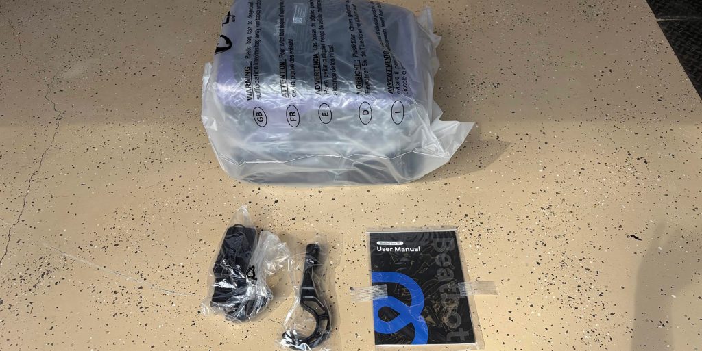 A plastic bag with a black object next to a black object