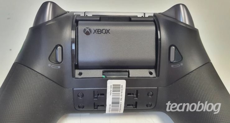 A black gaming controller with a white label