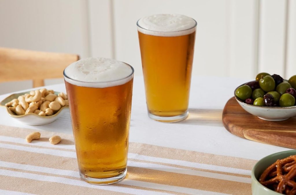 Two glasses of beer and nuts on a table