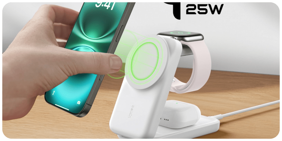 A hand holding a phone next to a device