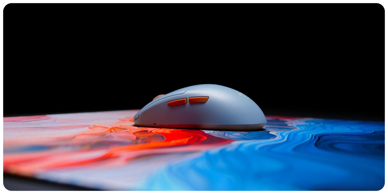 A computer mouse on a colorful surface