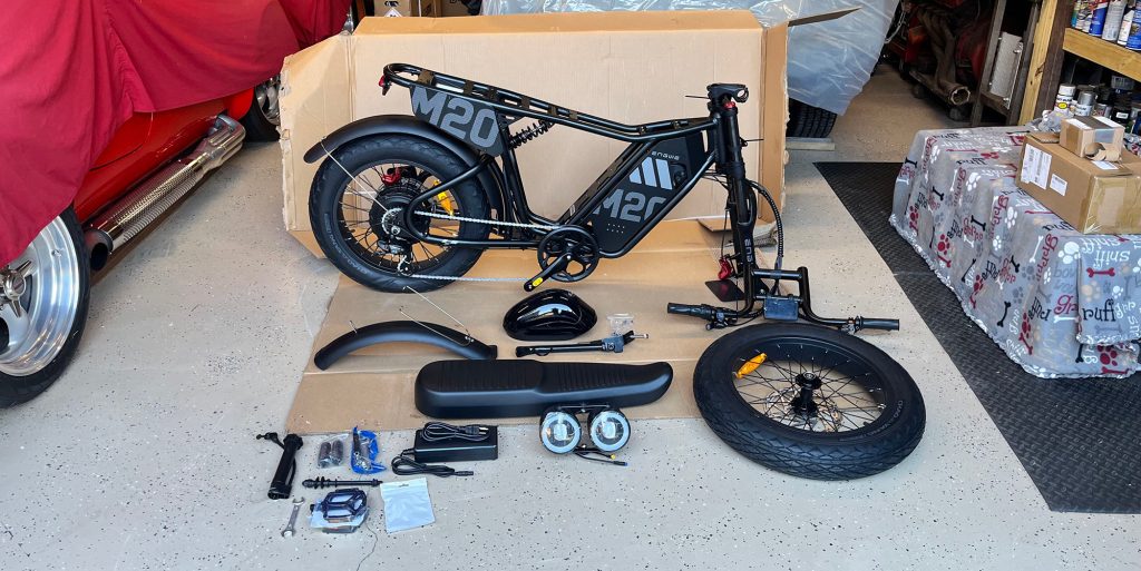 A black electric bike with parts on the floor