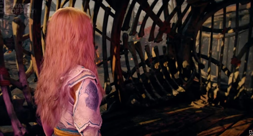A woman with pink hair and a white shirt