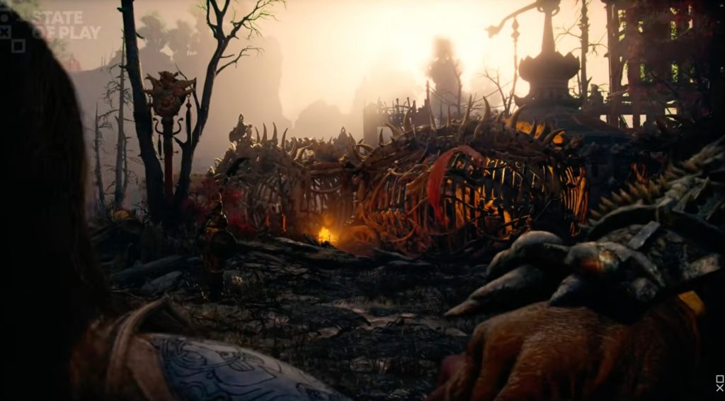 A video game scene of a graveyard with a fire and trees