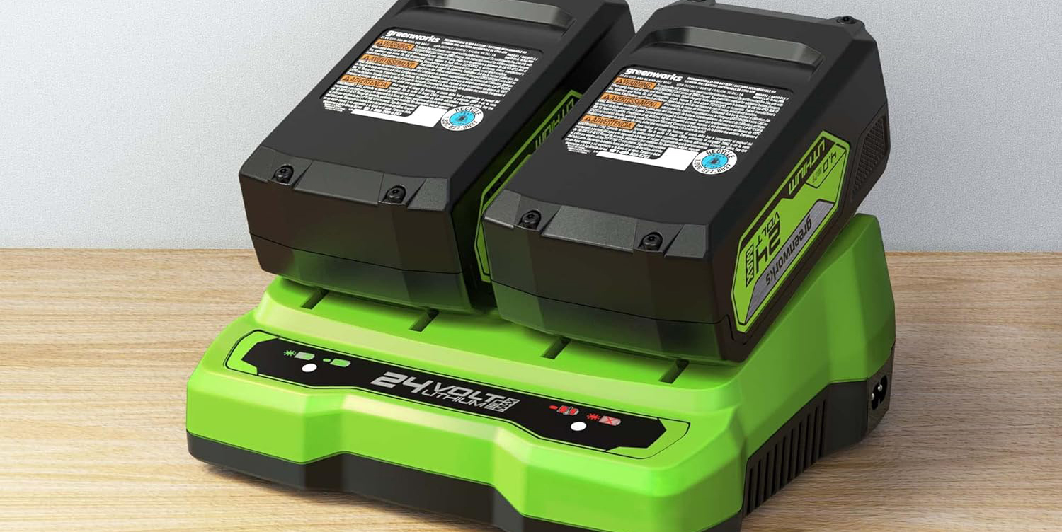 Two black and green batteries on a green and black device