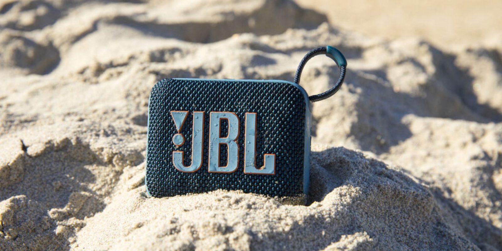 A blue speaker in the sand