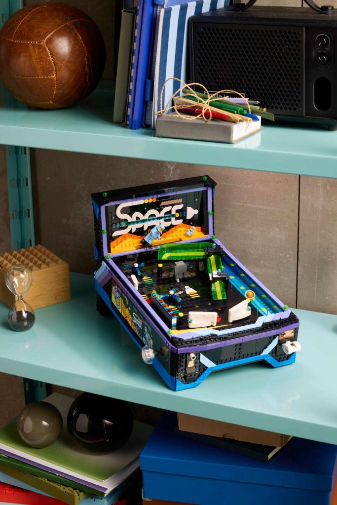 A toy arcade machine on a shelf