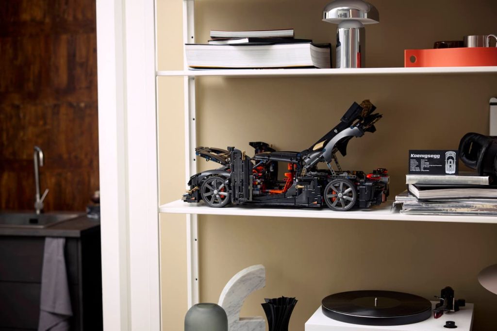 A white shelf with a toy car on it