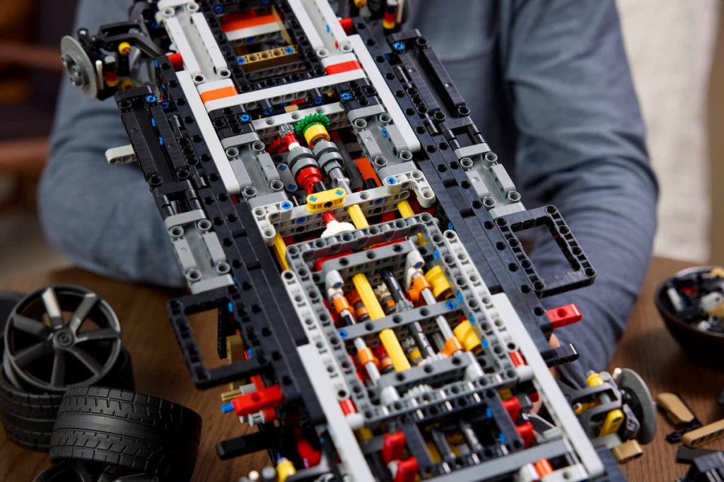 A person holding a lego car