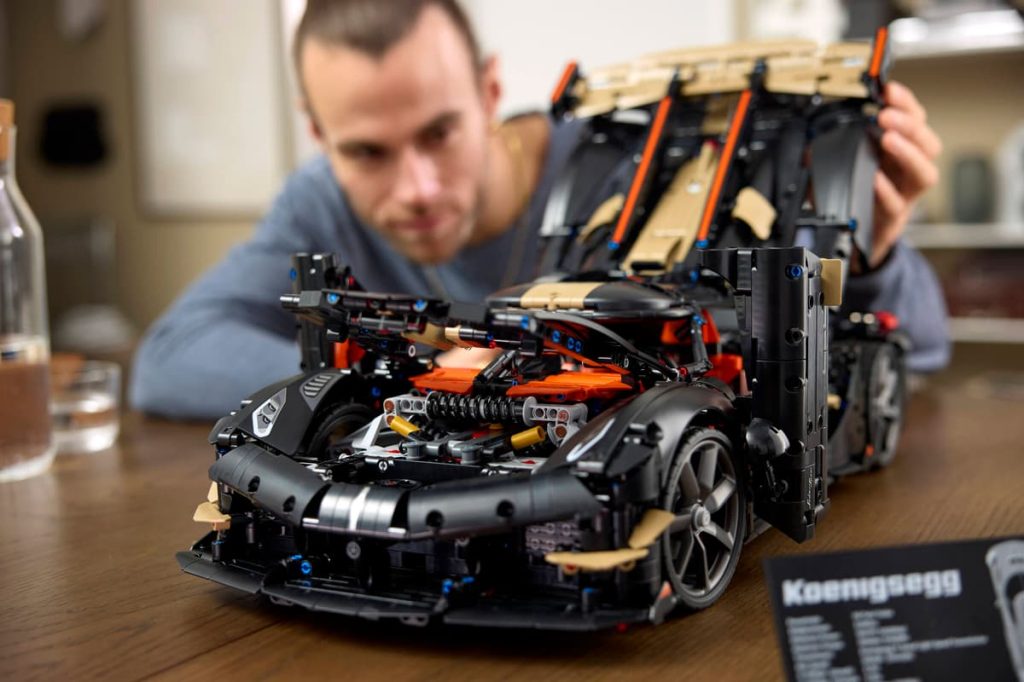 A man looking at a model of a car