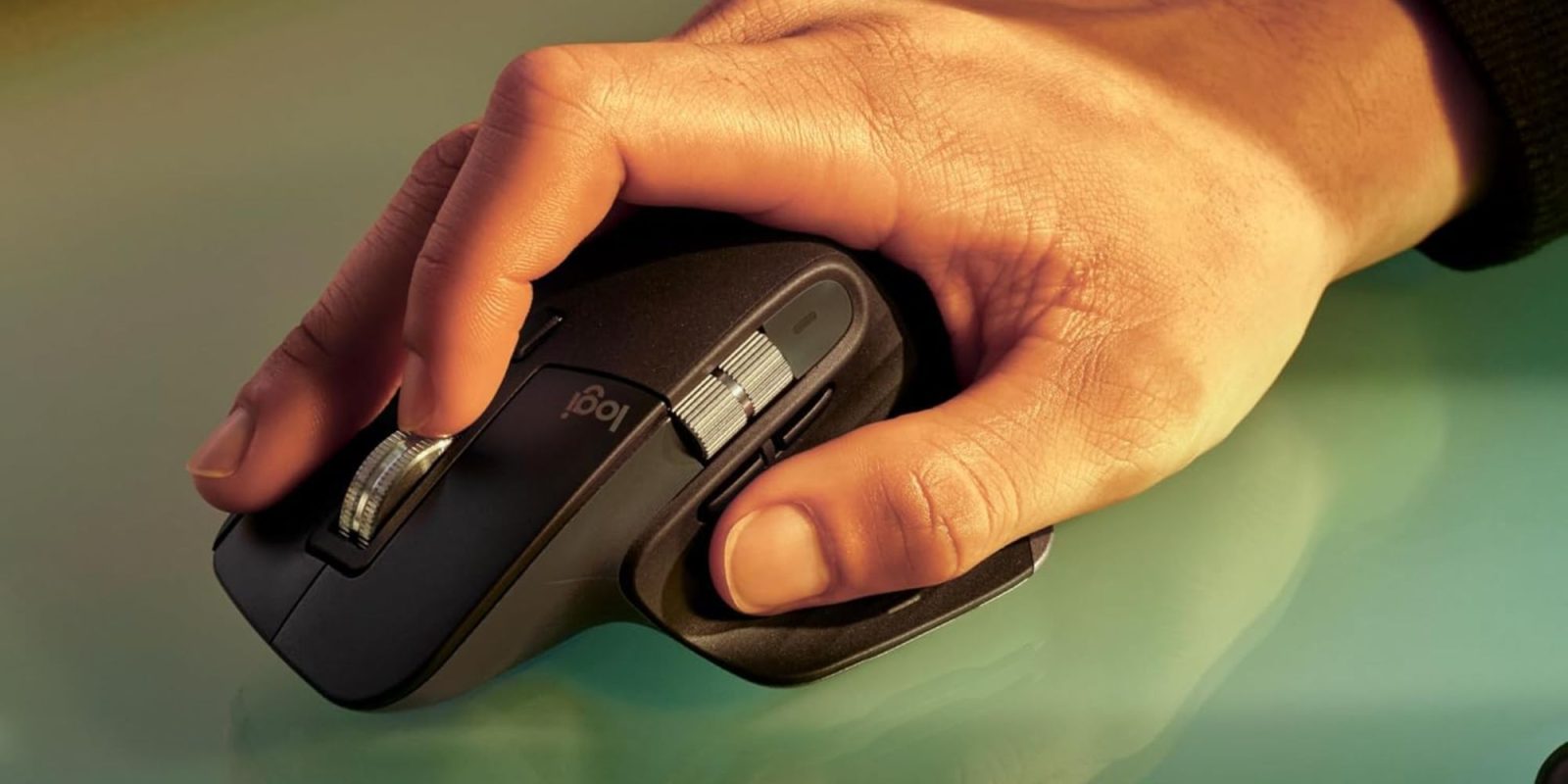 A hand holding a computer mouse