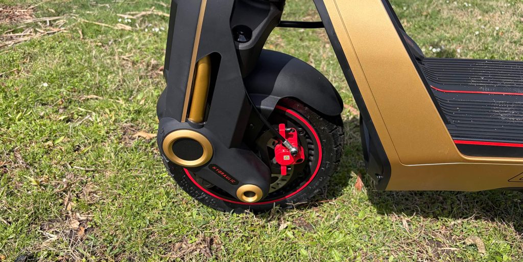 A black and gold scooter with red wheels