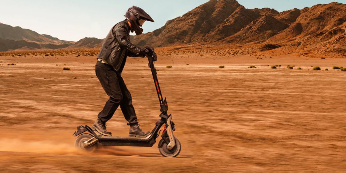 A person riding a scooter in the desert