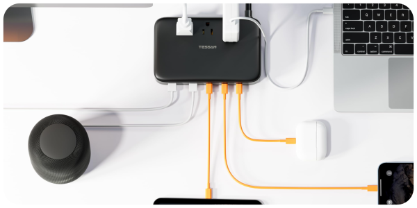 A black rectangular device with orange and white cables connected to it
