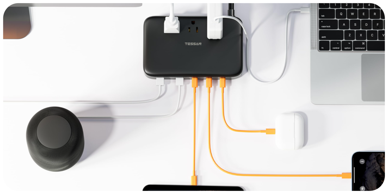 A black rectangular device with orange and white cables connected to it