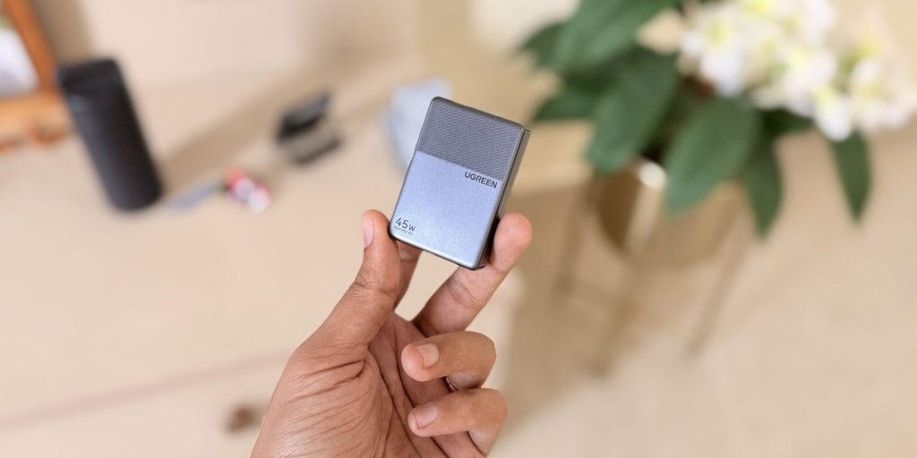 A hand holding a small rectangular object
