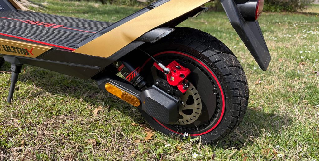 A black and gold scooter with red and black wheels