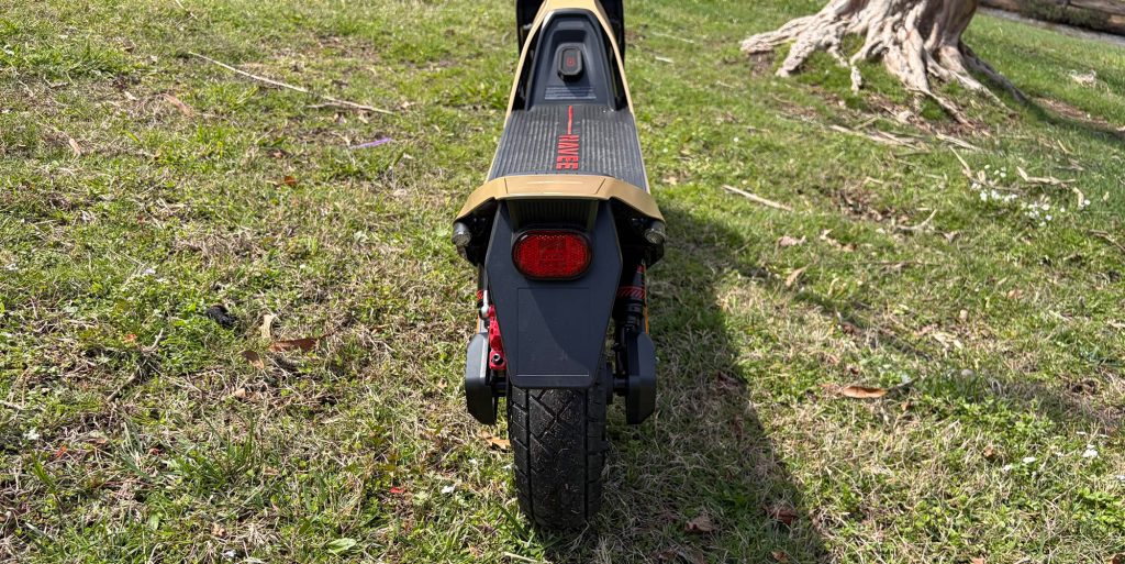 A black and gold scooter on grass