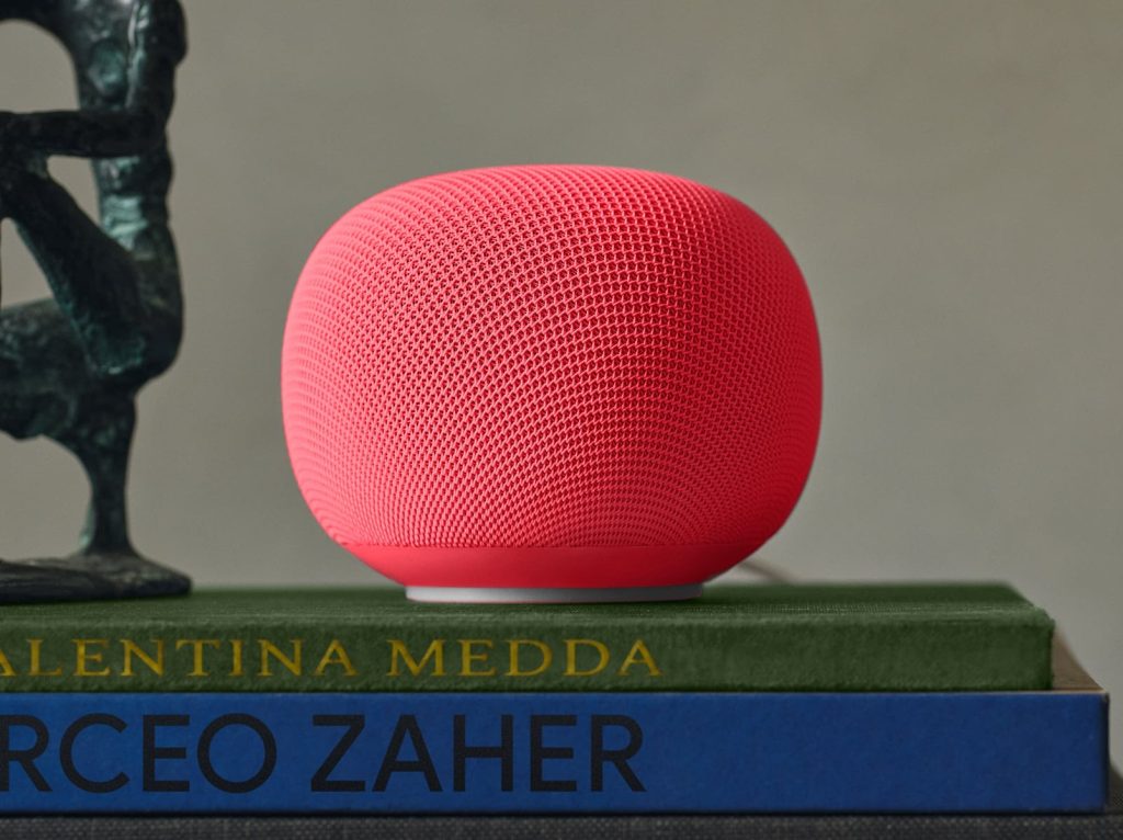 A red speaker on top of books