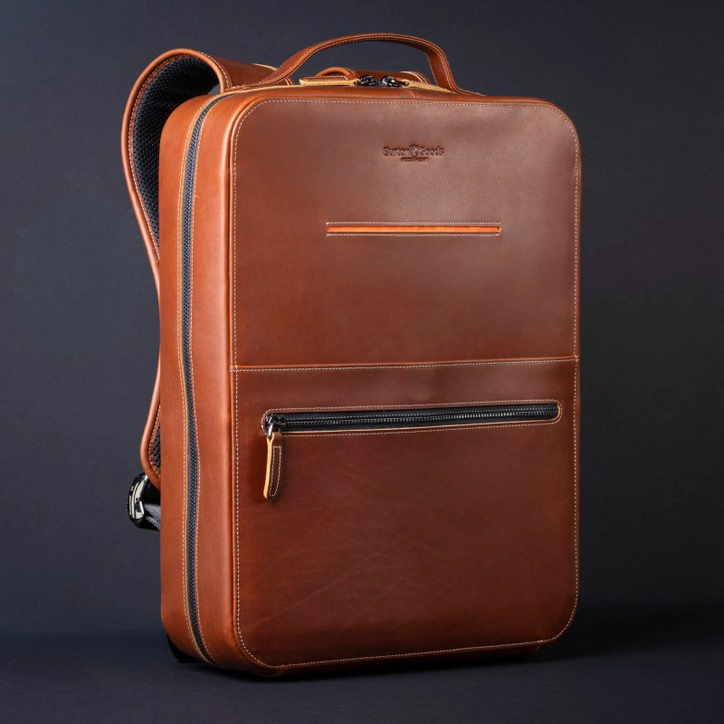 A brown leather backpack with zippers