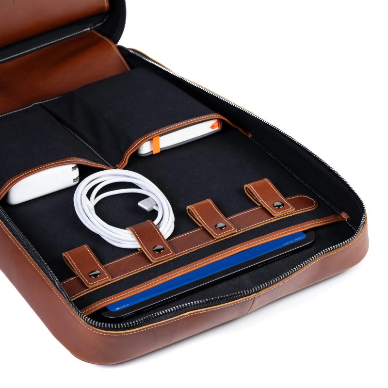 A brown leather case with a white cord inside
