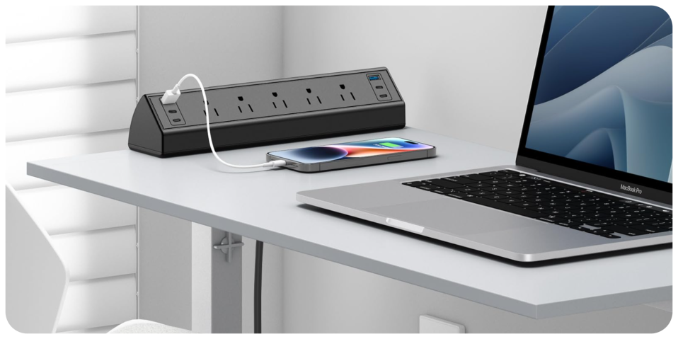 A cell phone charging on a laptop