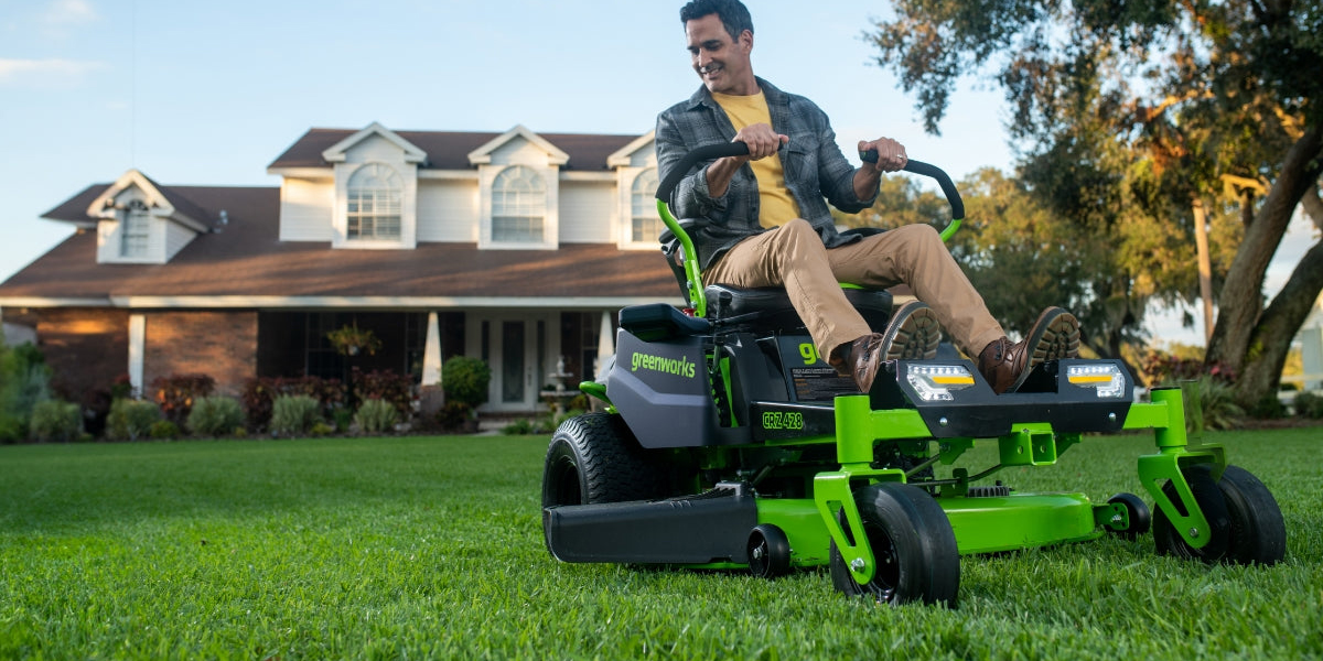A man sitting on a lawn mower
