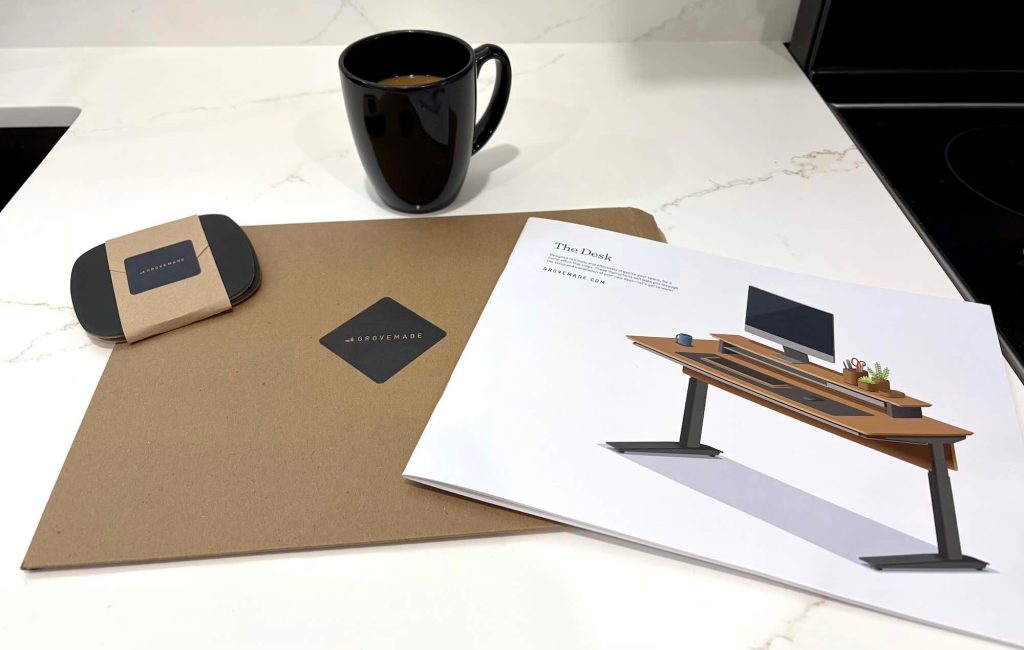 A coffee cup and a drawing of a desk