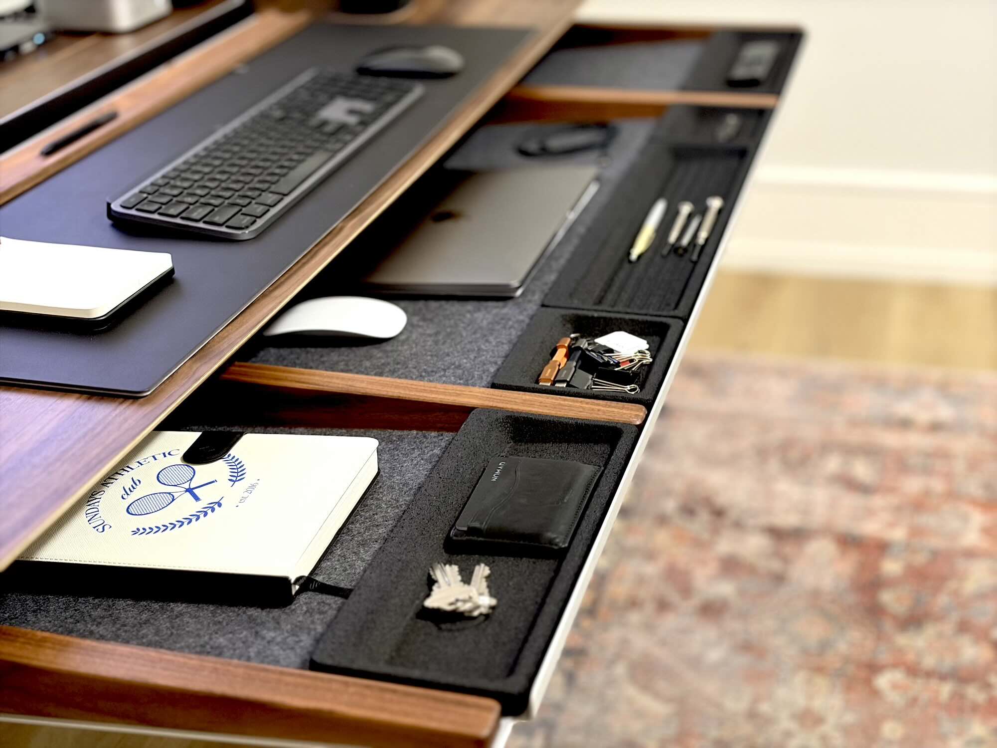 A desk with a keyboard and other objects