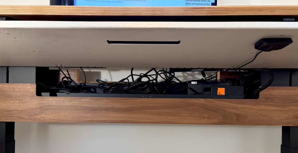 A shelf with a computer and wires