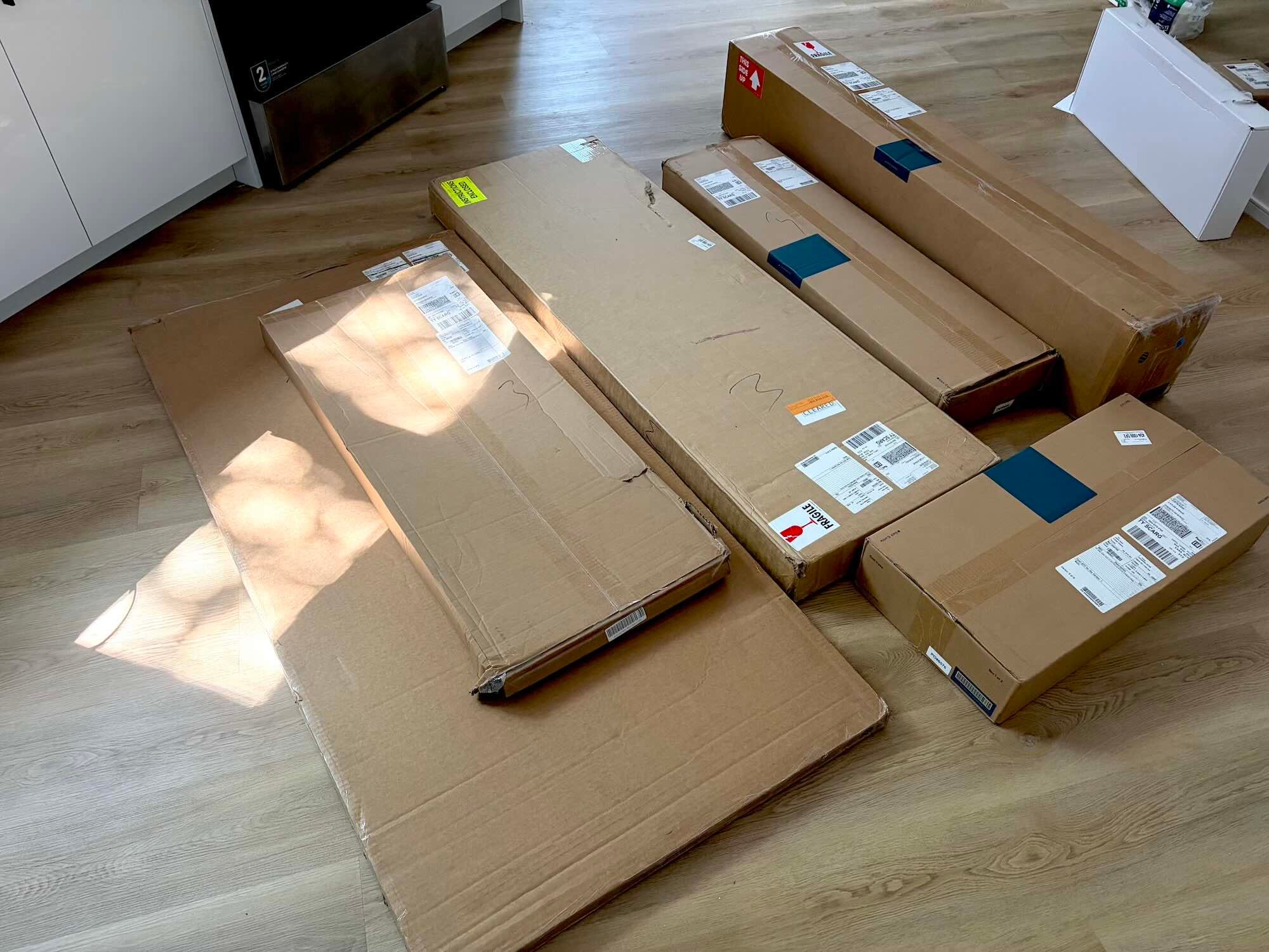 A group of cardboard boxes on a wood floor
