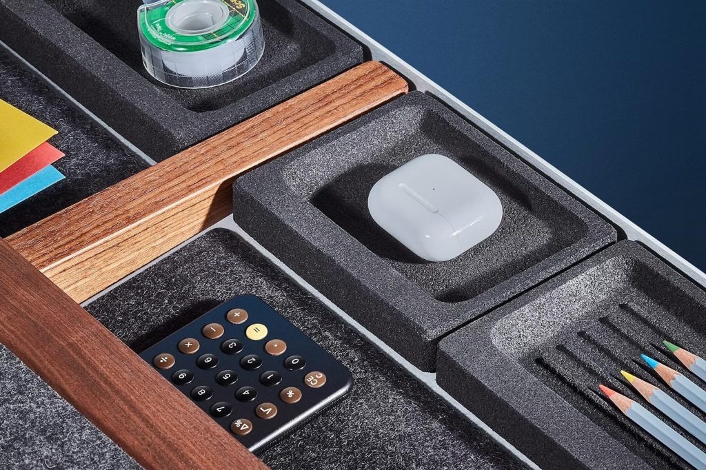 A box with a calculator and a white object in it
