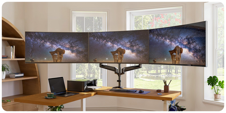A desk with multiple screens