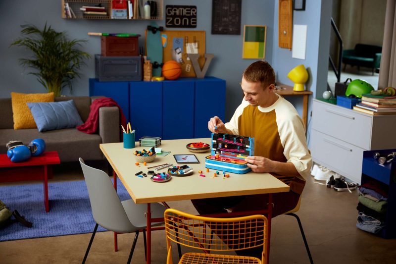 A man sitting at a table with toys