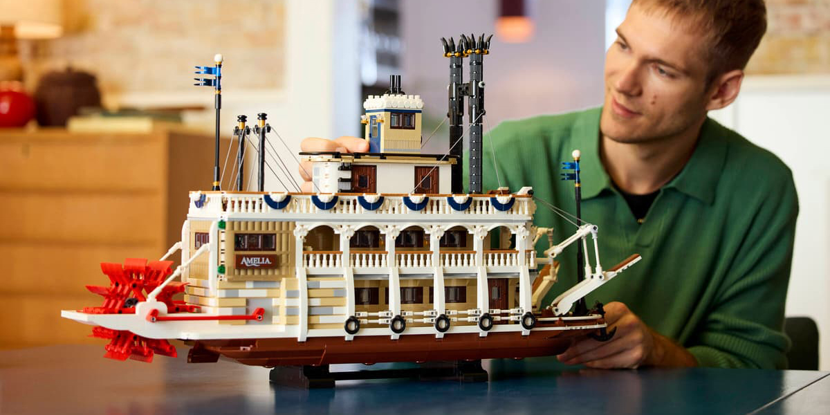 A man holding a model of a boat