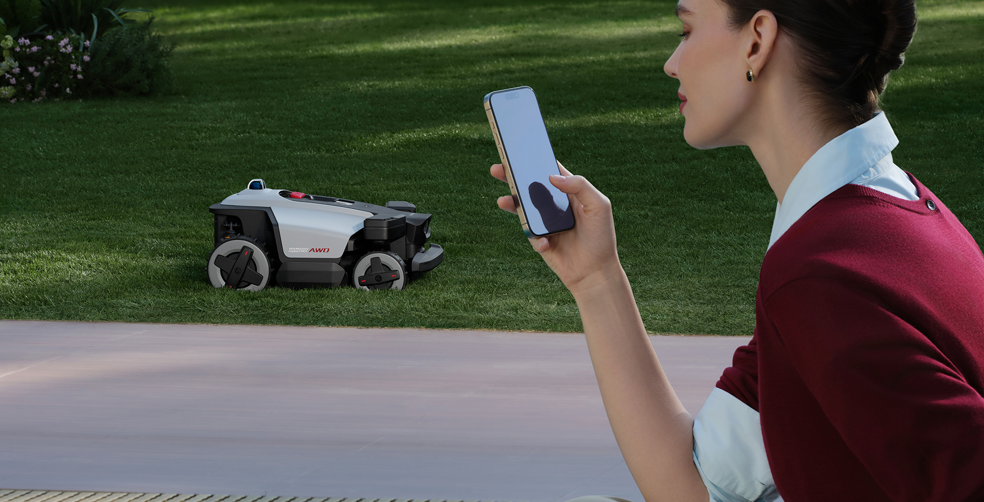 A woman holding a phone in front of a robot