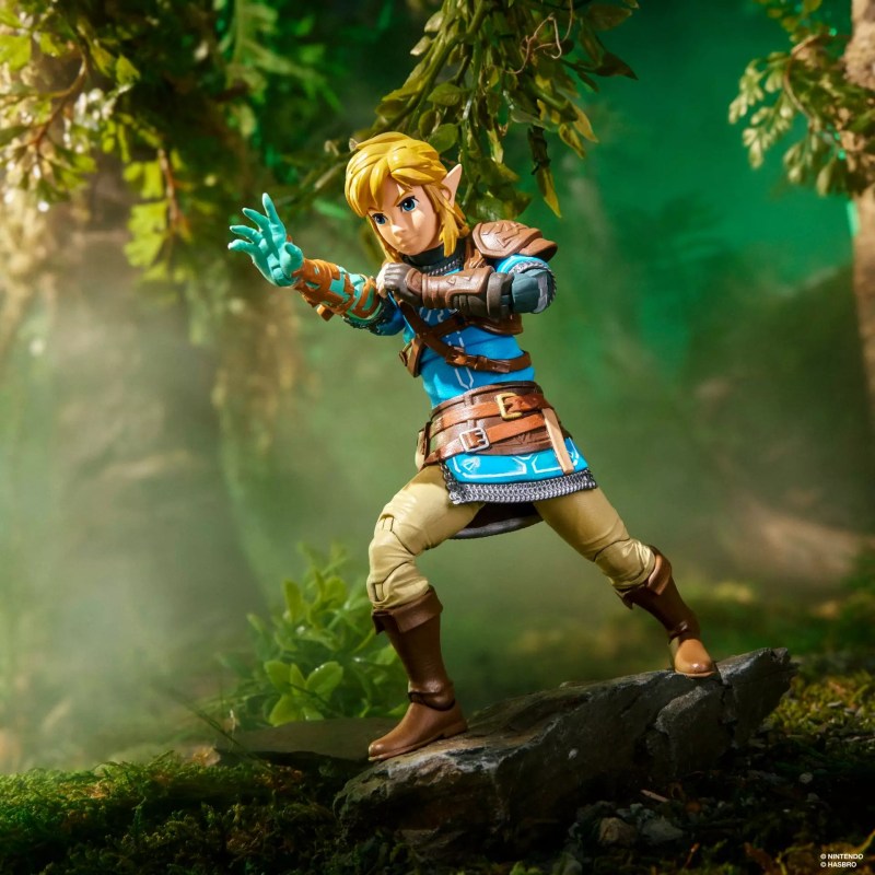 A toy figurine of a man in a forest