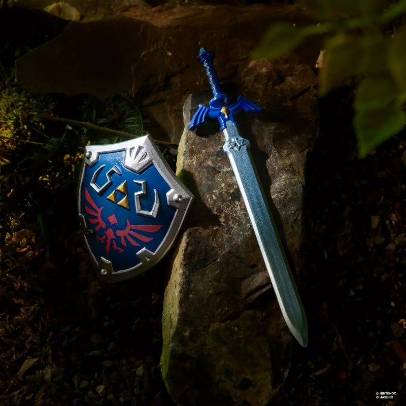 A toy sword and shield on a rock