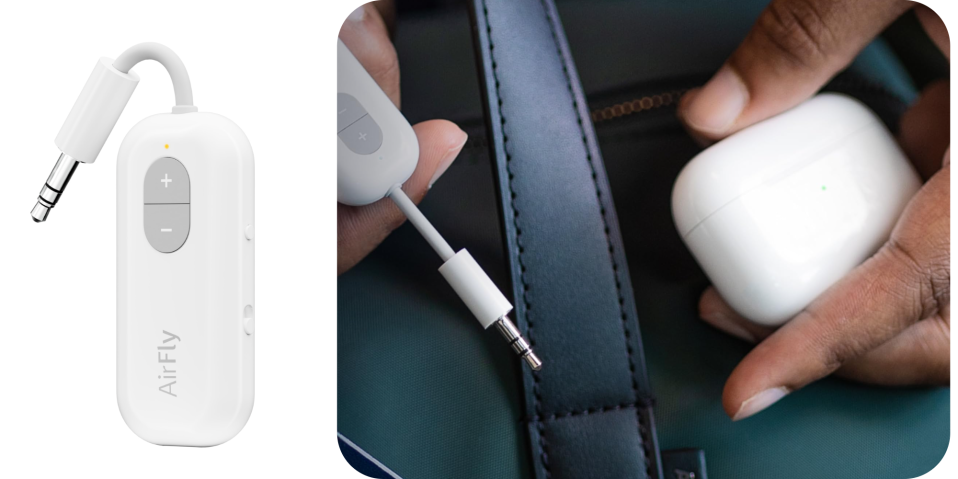 A close up of a hand holding a white earbud