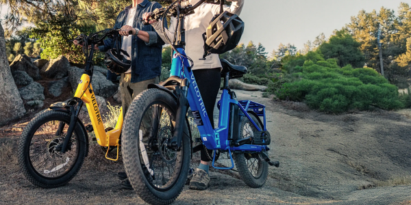 A man and woman standing next to a blue bike