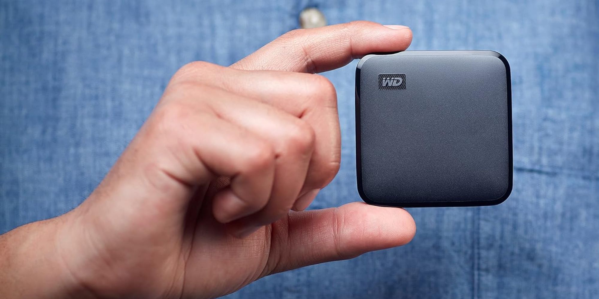A hand holding a black rectangular object